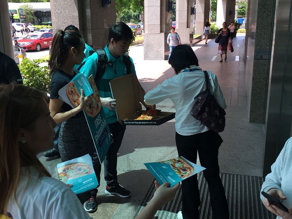 High foot traffic pedestrian crossing in Singapore during peak hours, suitable for flyer distribution jobs and street marketing